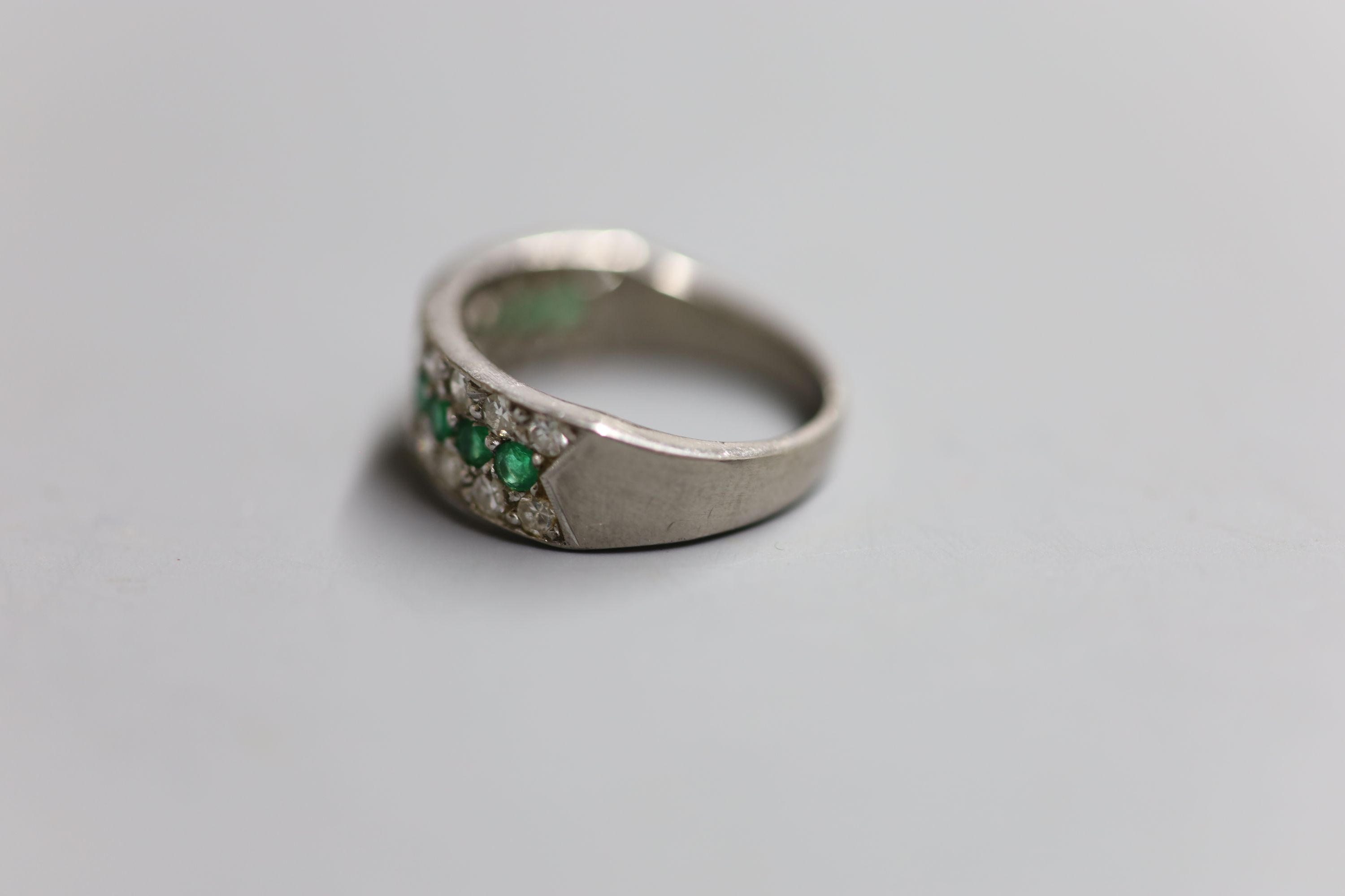 A modern 18ct white metal, emerald and diamond three row half hoop ring, size Q, gross 6.7 grams.